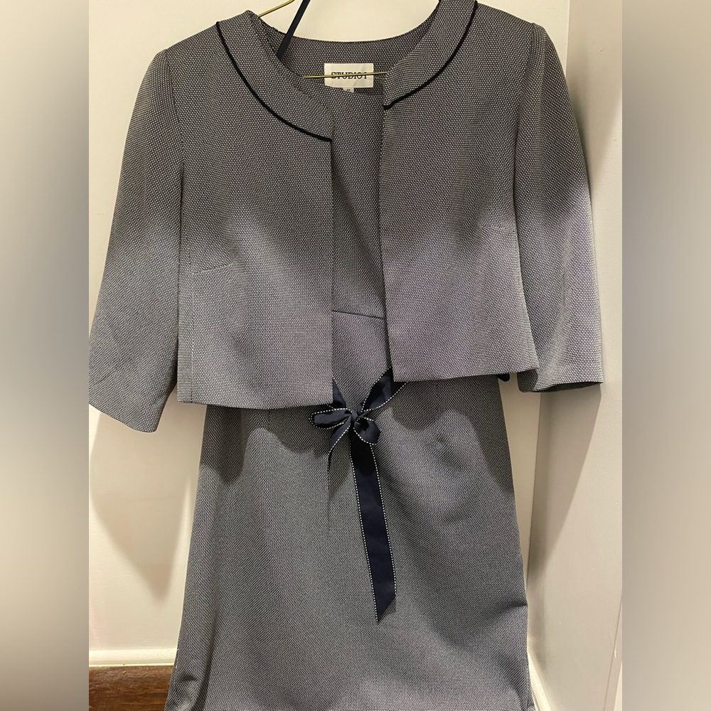 Studio 1 grey dress, with black bow, and grey jacket.